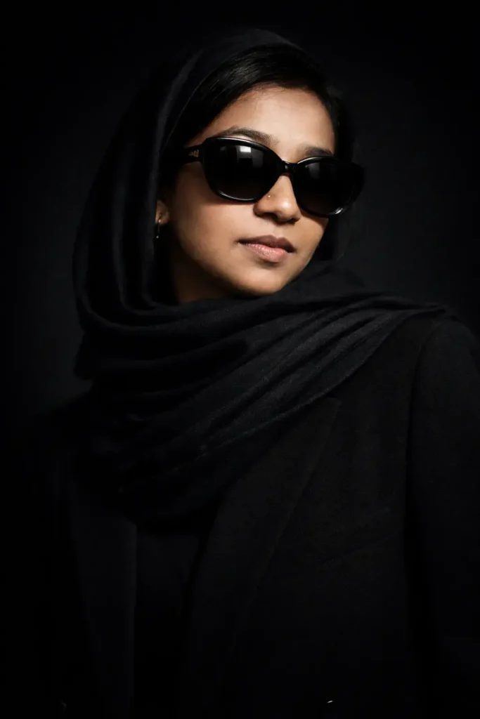 woman in black suit and scarf wearing sunglasses, the best digital marketing strategist in Kannur portrait